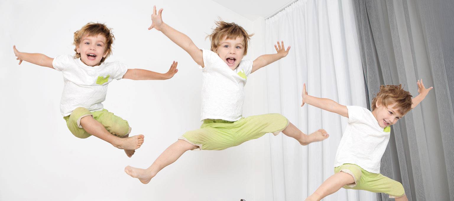 boys jumping star shape on bed