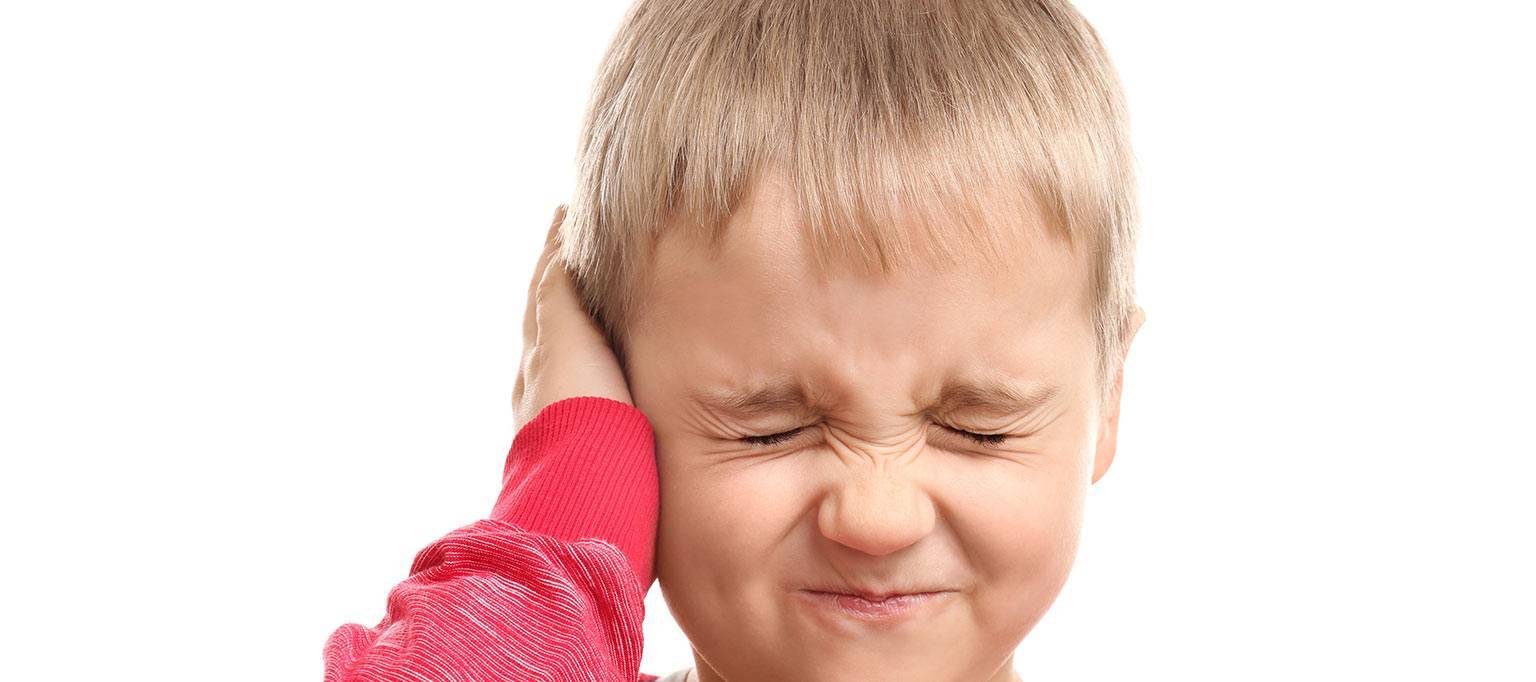 child holding ear flinching
